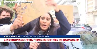 A rep&oacute;rter Ana&iuml;s Mar&eacute;chal se desvencilha dos cartazes colocados &agrave; sua frente para tentar trabalhar Foto: Reprodu&ccedil;&atilde;o